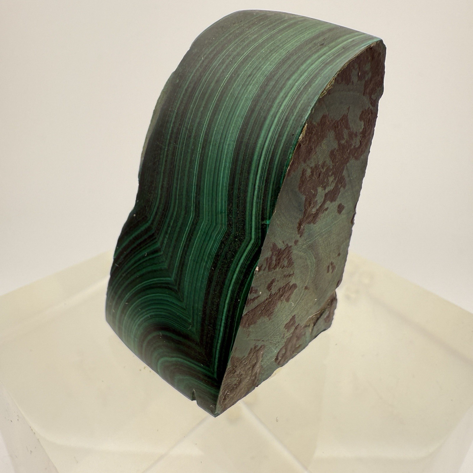 Dark green banded malachite on a lucite Base artist Unknown Signed – “?” Ax