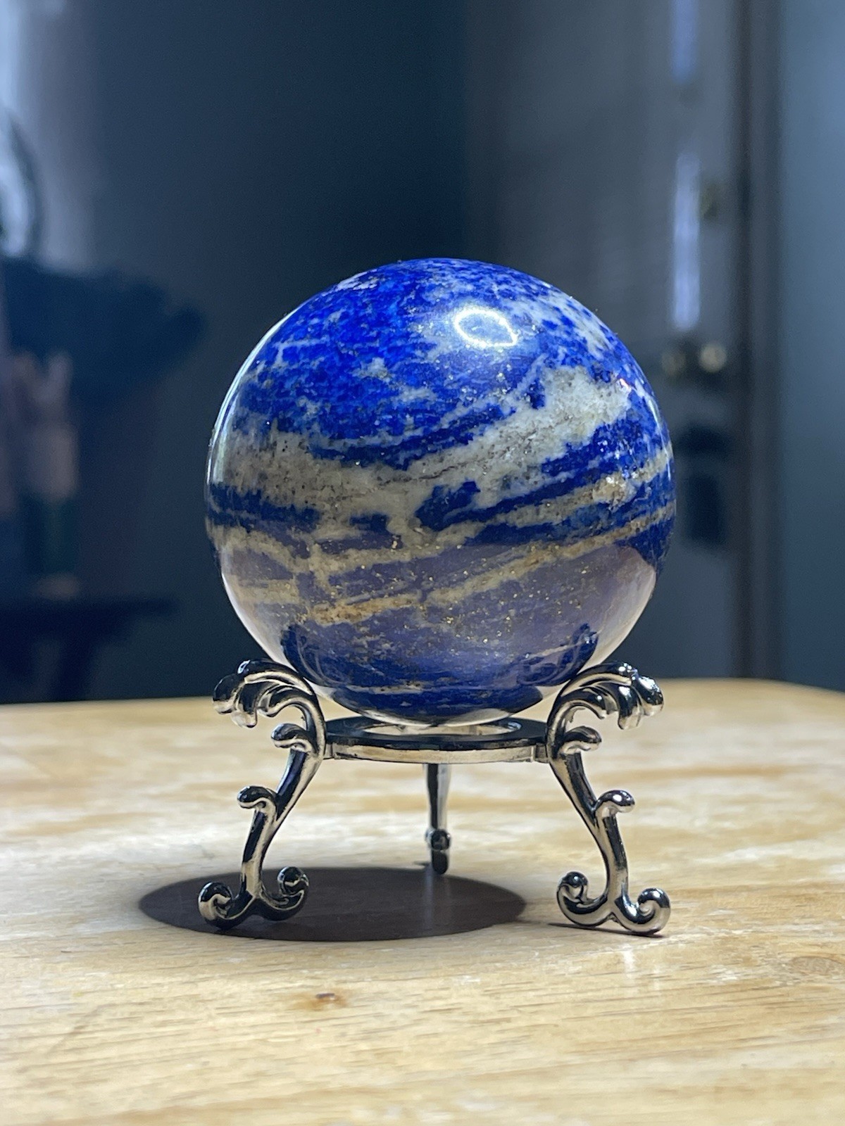 Polished Lapiz Lazuli Sphere with Pyrite Inclusions on Display Stand