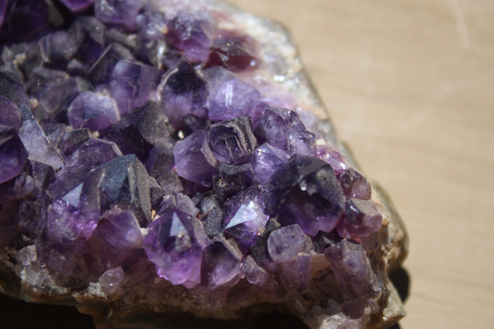 Amethyst geode specimen with brass holder
