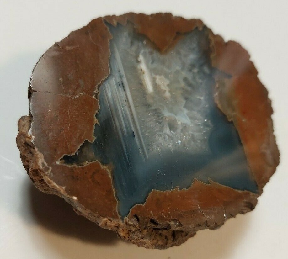 ENHYDRO AGATE GEODE. 3″ X 2 1/2″. LIGHT SHINES THRU LEAVES A YELLOWISH HUE