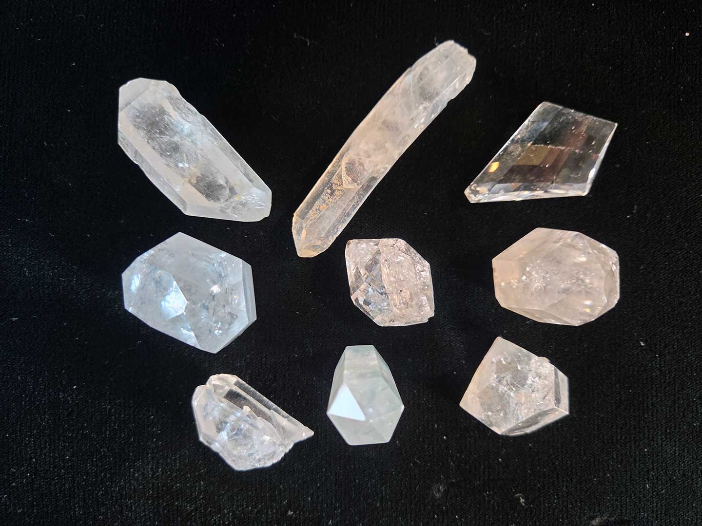 Collection of 9 clear quartz crystal points, 1in. to 3in.