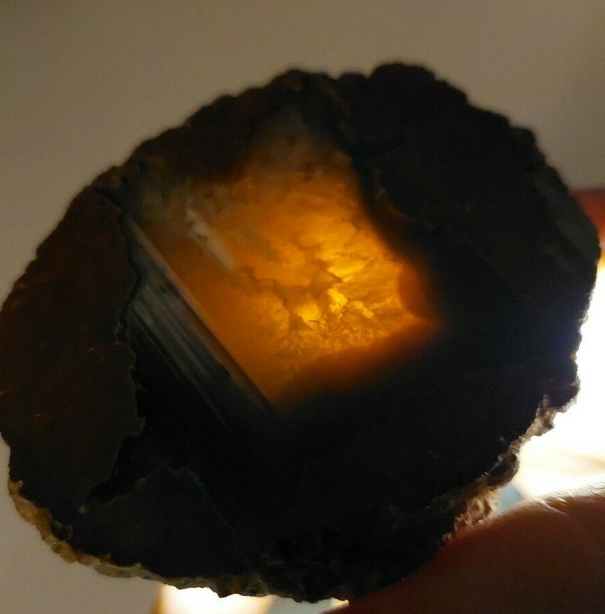 ENHYDRO AGATE GEODE. 3″ X 2 1/2″. LIGHT SHINES THRU LEAVES A YELLOWISH HUE