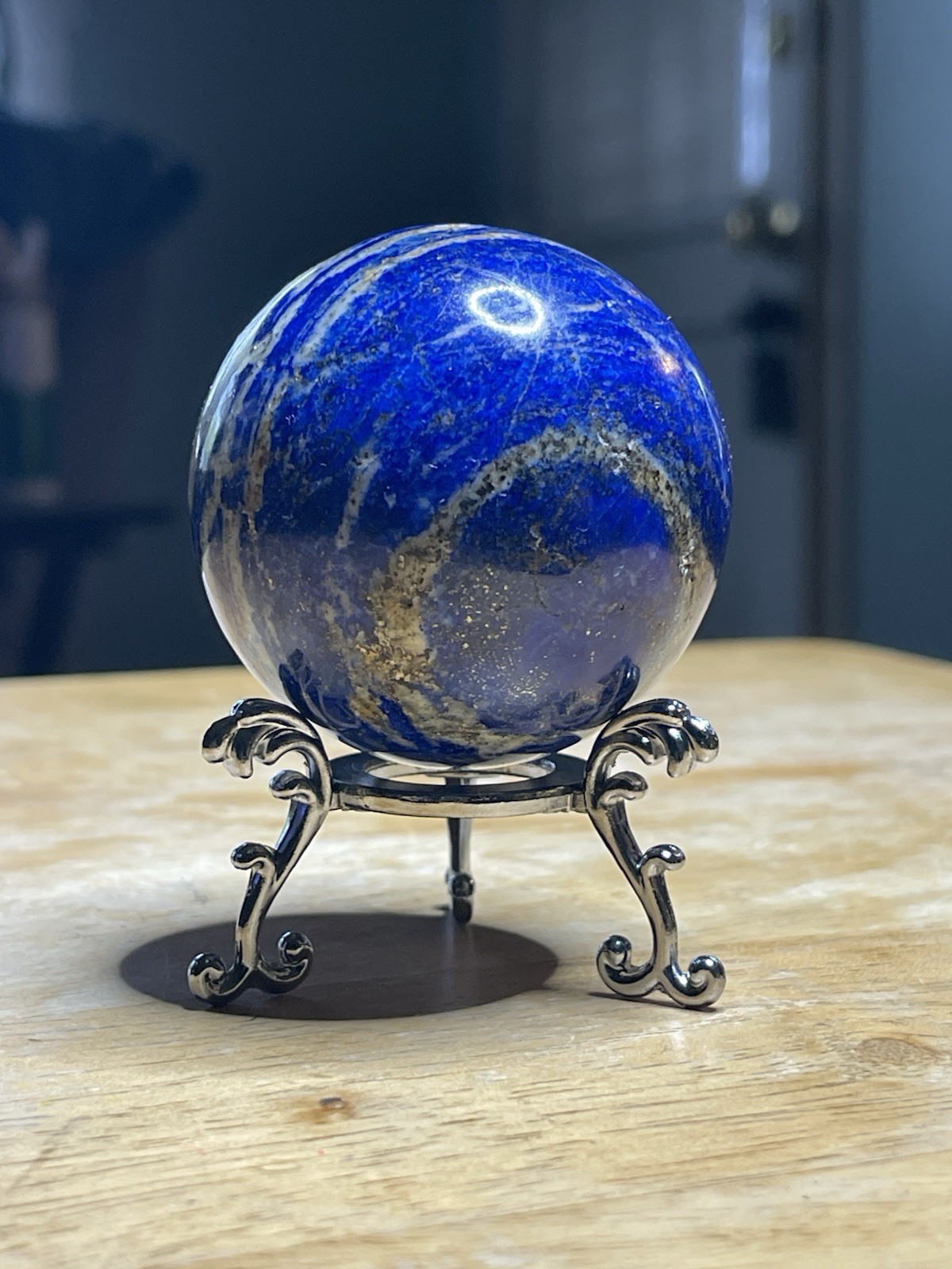 Polished Lapiz Lazuli Sphere with Pyrite Inclusions on Display Stand