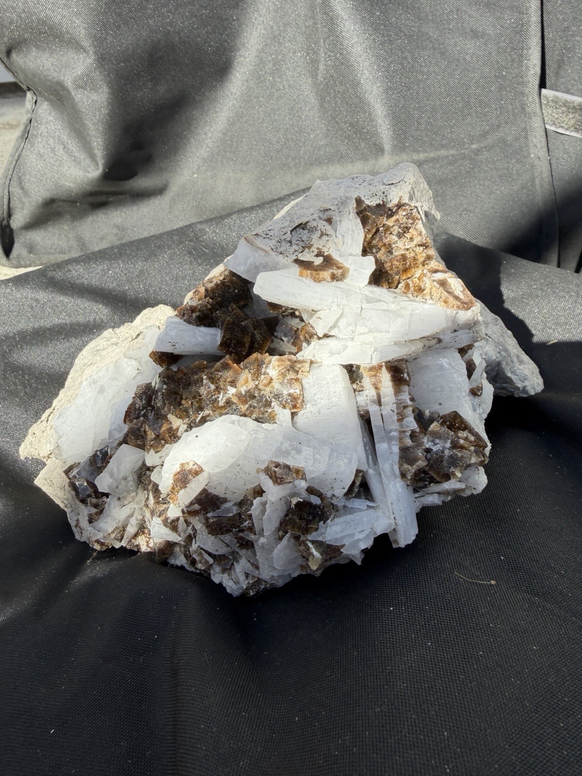Mineral specimen containing brown fluorite and white celestite crystals.