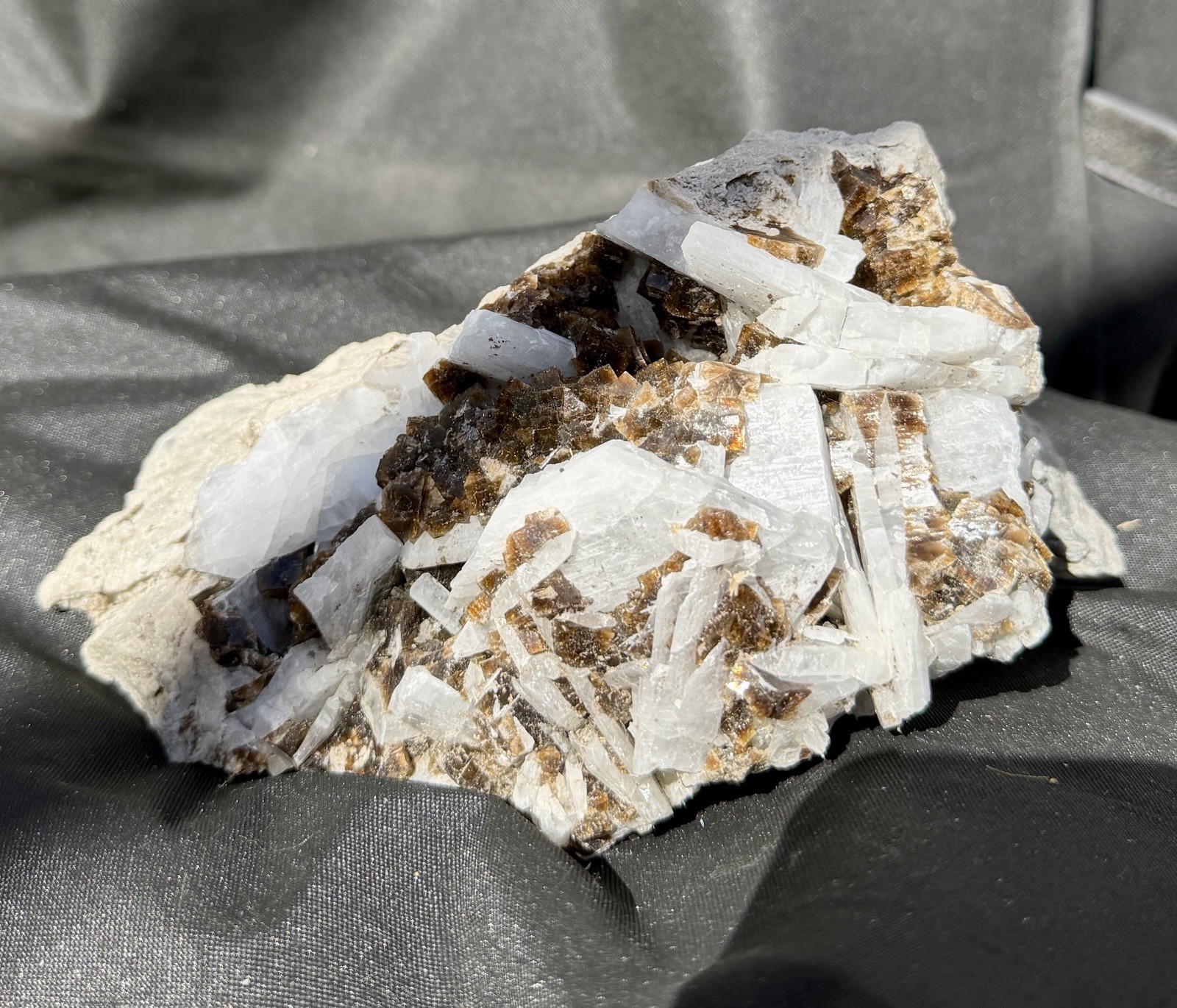 Mineral specimen containing brown fluorite and white celestite crystals.
