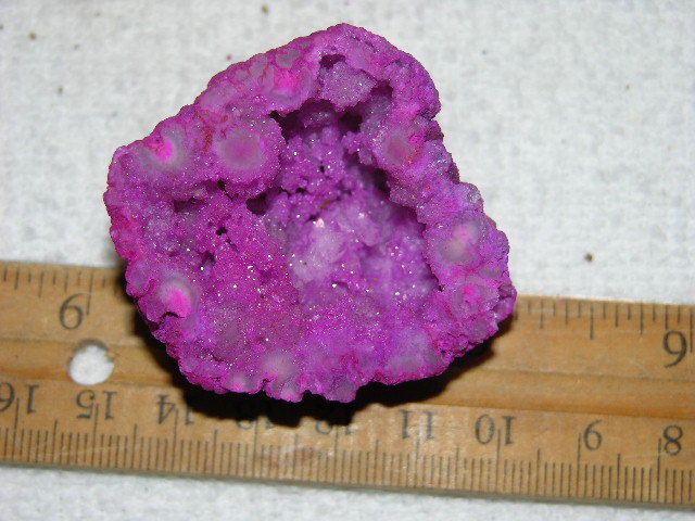 Geode cut & polished half with colored crystal center 2 inch E20