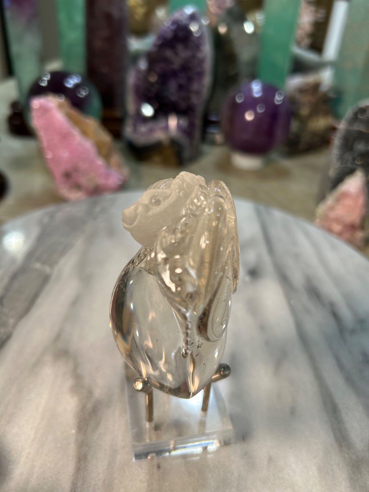 Clear quartz Golden Toad on peach carving very clear