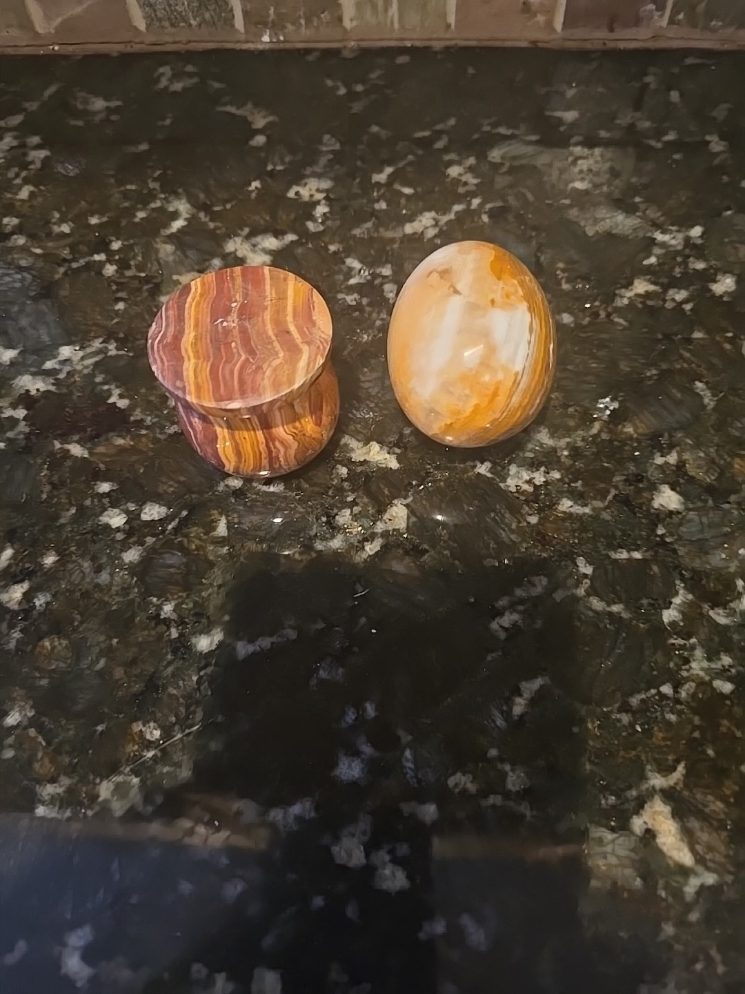 Polished Banded Onyx Egg On A marble Stand