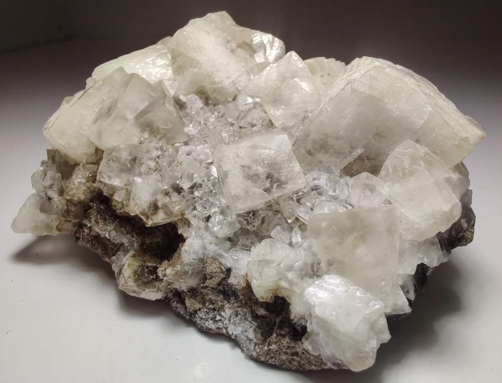 Calcite crystals on matrix, unique form, fluorescent white. 215 grams.