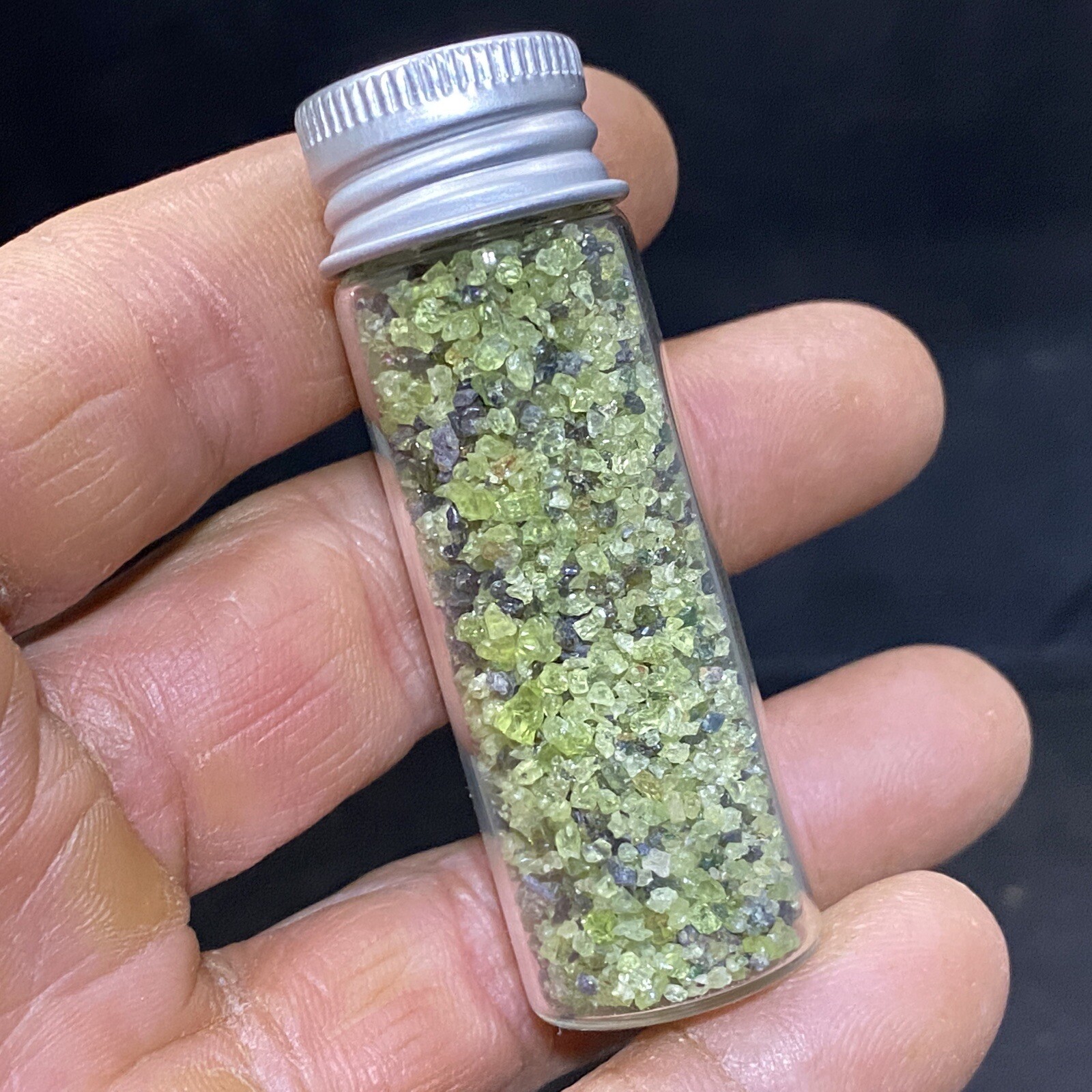 Green Peridot Crystals in a Glass Bottle Jar