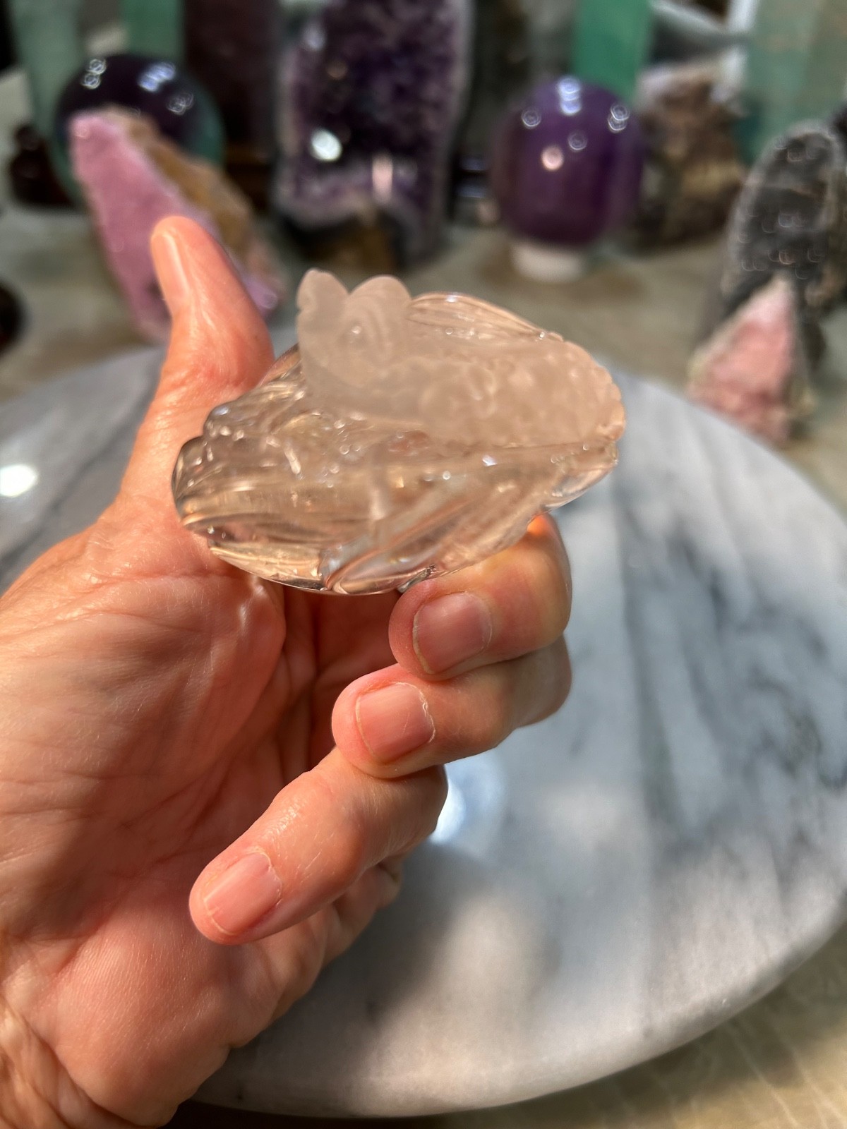 Clear quartz Golden Toad on peach carving very clear