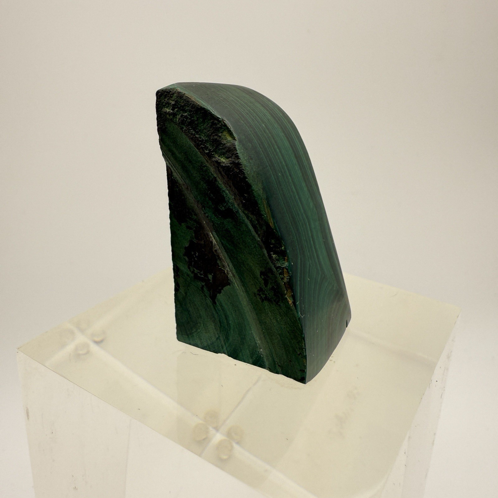 Dark green banded malachite on a lucite Base artist Unknown Signed – “?” Ax