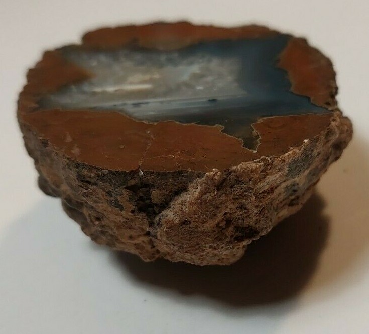 ENHYDRO AGATE GEODE. 3″ X 2 1/2″. LIGHT SHINES THRU LEAVES A YELLOWISH HUE