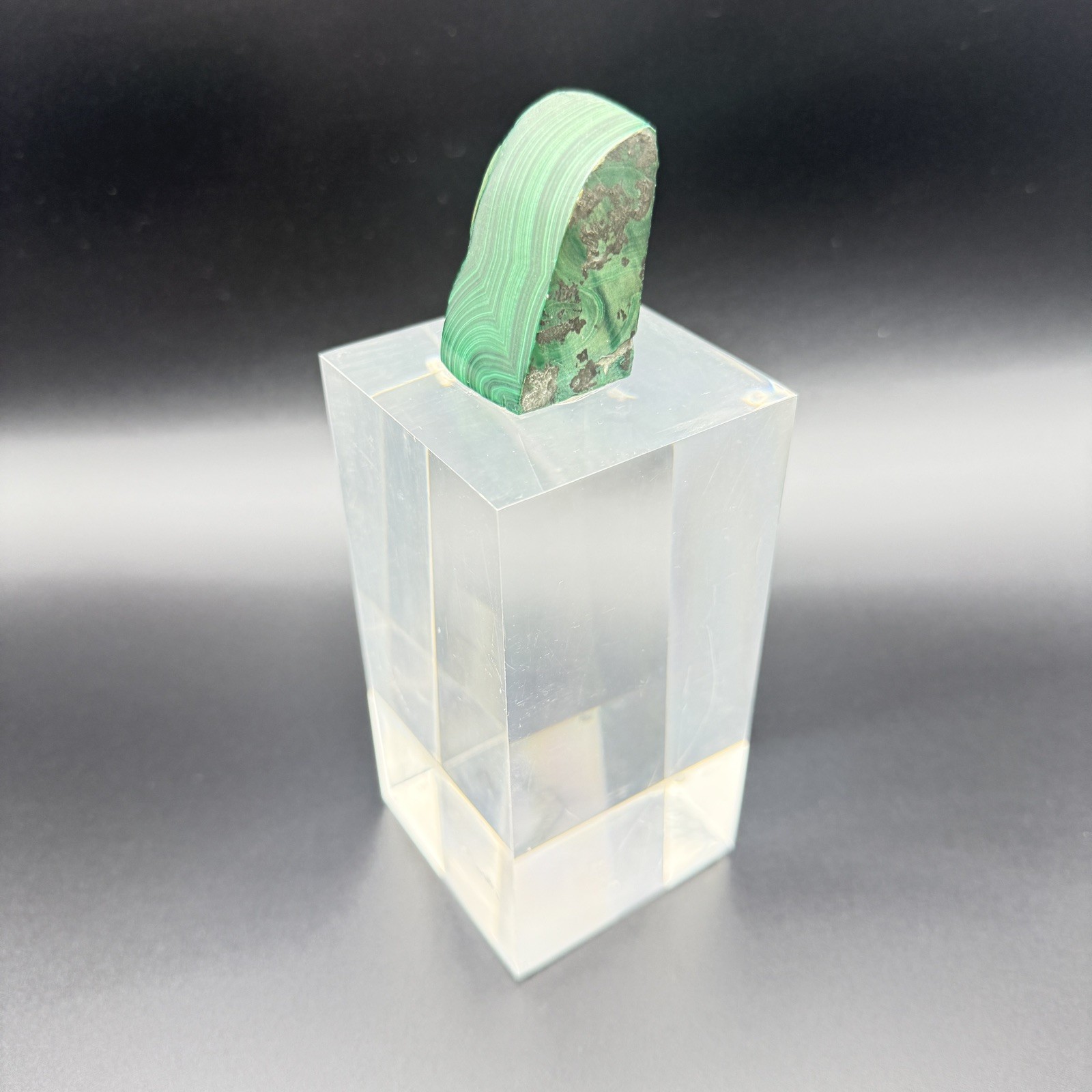 Dark green banded malachite on a lucite Base artist Unknown Signed – “?” Ax