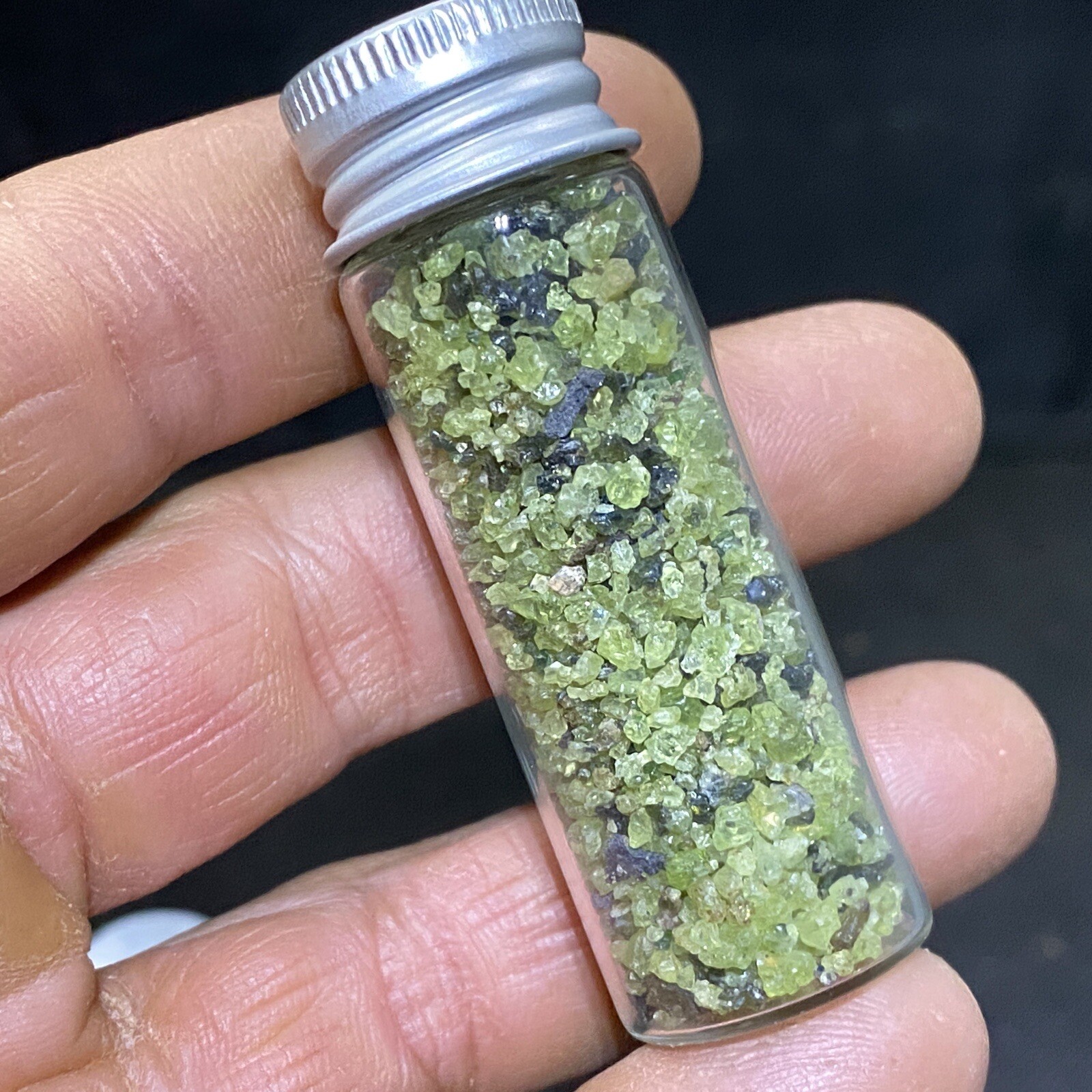 Green Peridot Crystals in a Glass Bottle Jar