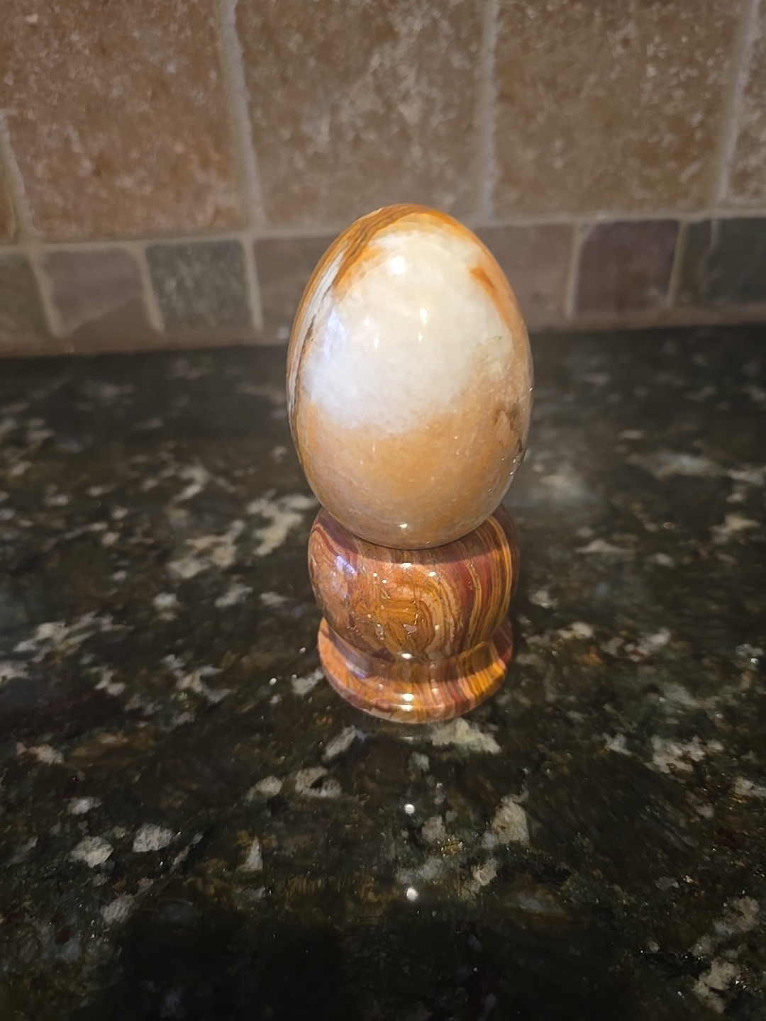 Polished Banded Onyx Egg On A marble Stand