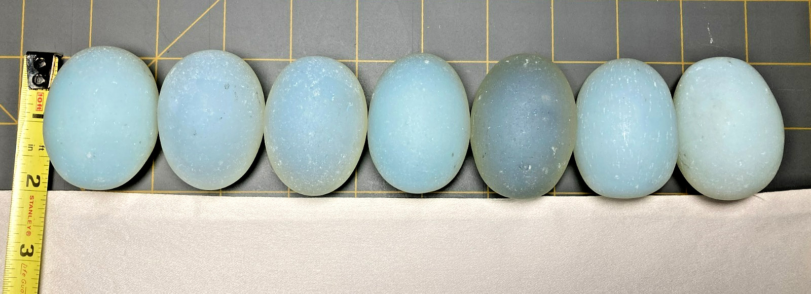 Seven Opalite Glass Eggs; 2 Inches Long; Milky Blue to Blue Green in Color