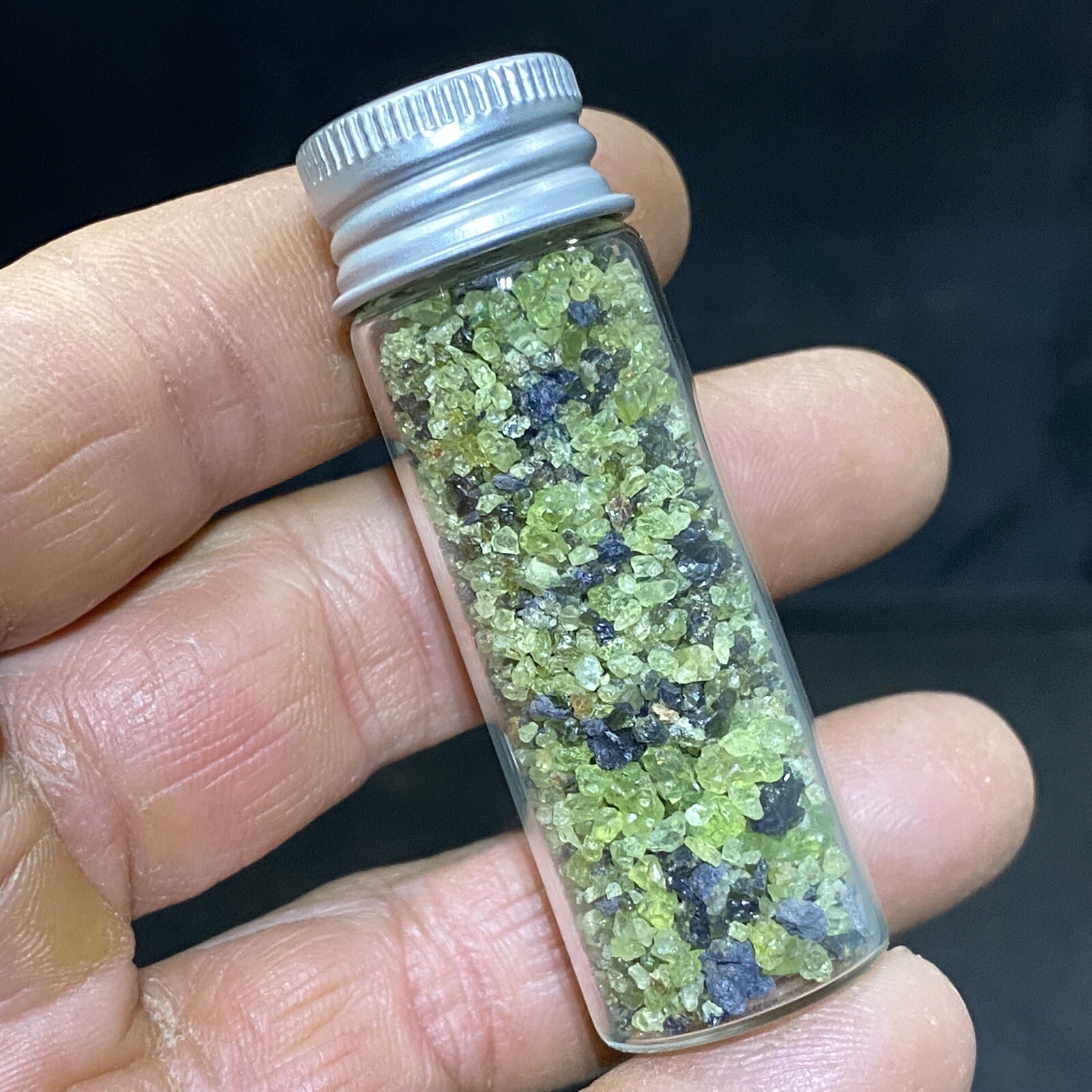 Green Peridot Crystals in a Glass Bottle Jar