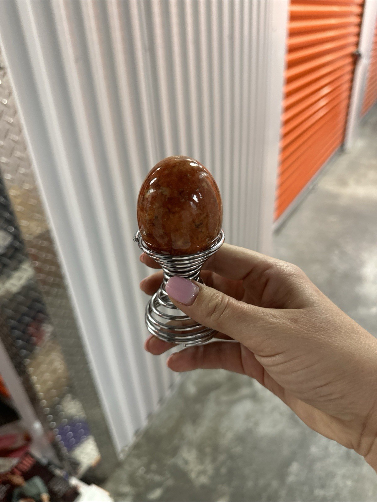 Red Crystal Egg-Shaped Mineral Specimen with Decorative Metal Display Stand
