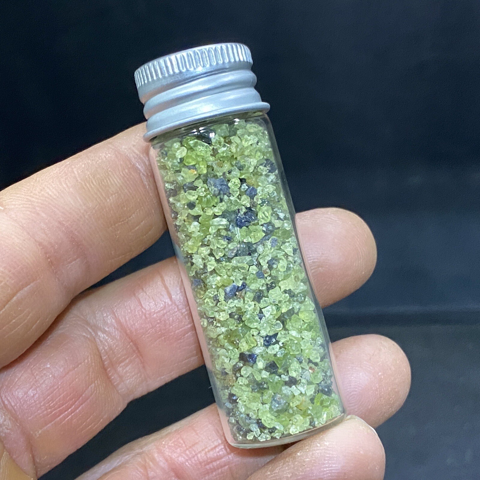 Green Peridot Crystals in a Glass Bottle Jar