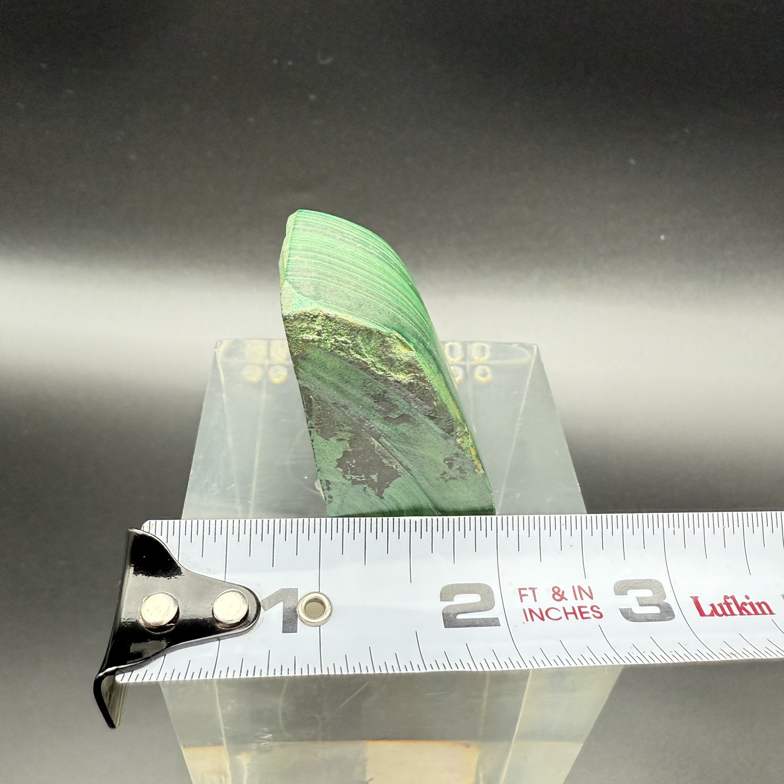 Dark green banded malachite on a lucite Base artist Unknown Signed – “?” Ax