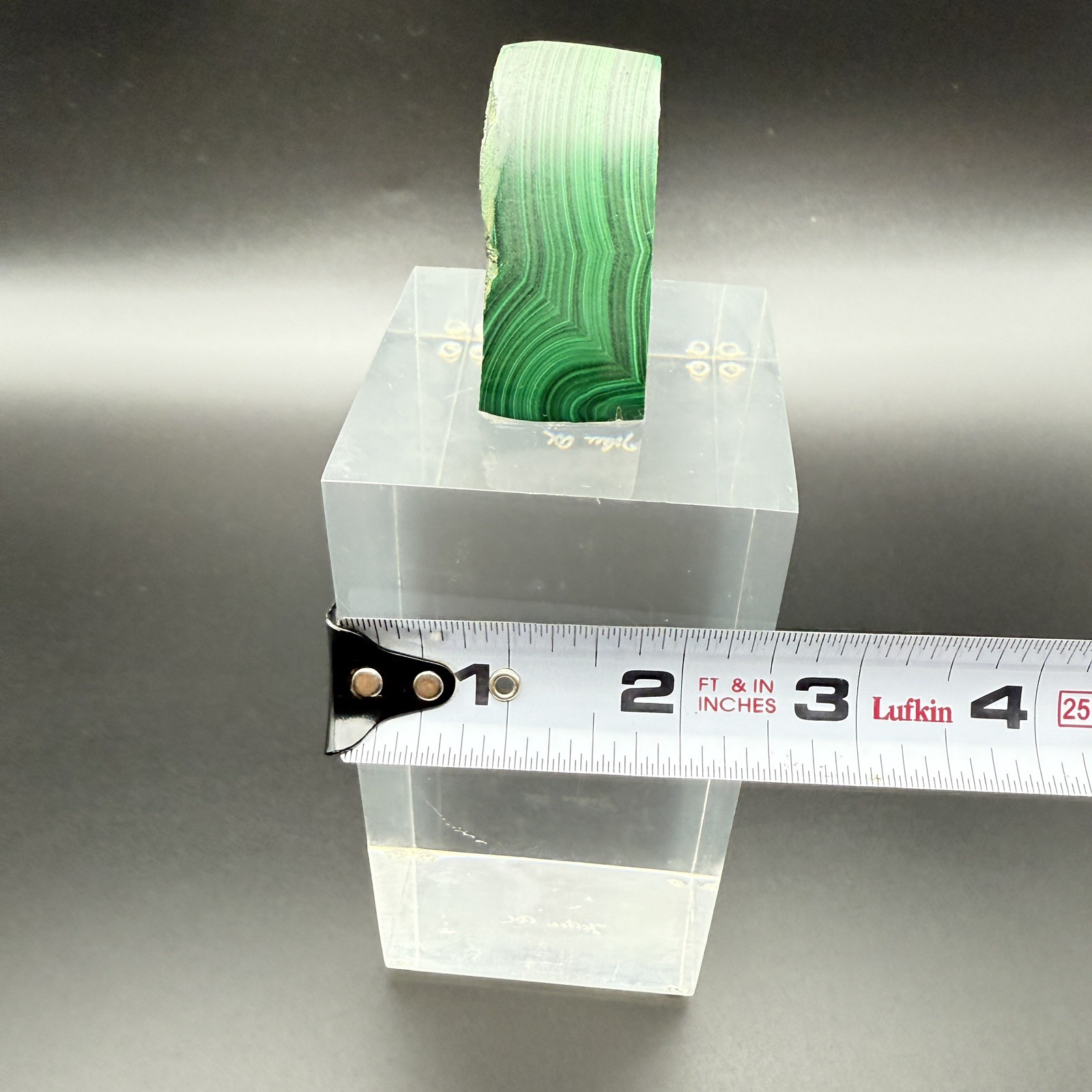 Dark green banded malachite on a lucite Base artist Unknown Signed – “?” Ax