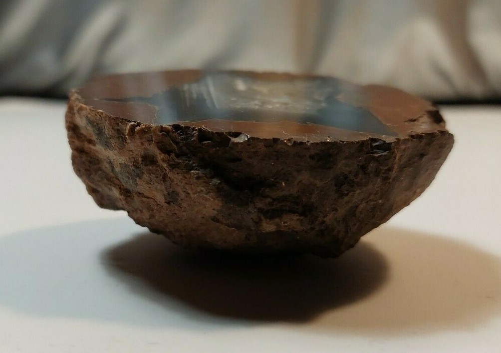 ENHYDRO AGATE GEODE. 3″ X 2 1/2″. LIGHT SHINES THRU LEAVES A YELLOWISH HUE