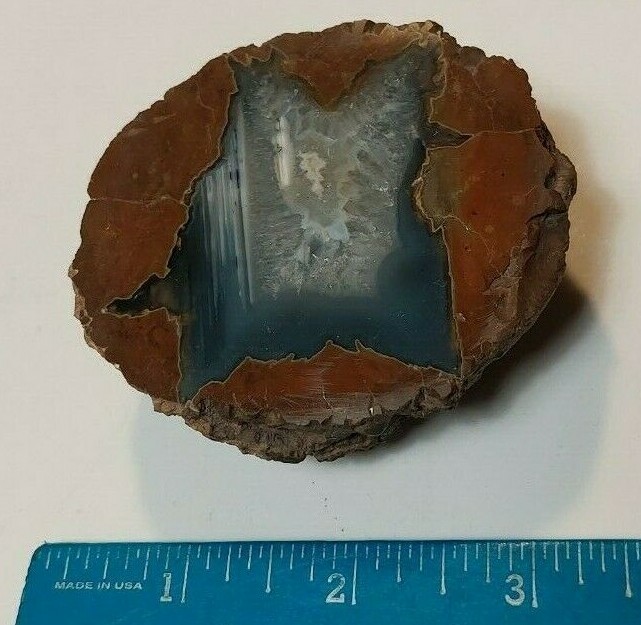 ENHYDRO AGATE GEODE. 3″ X 2 1/2″. LIGHT SHINES THRU LEAVES A YELLOWISH HUE