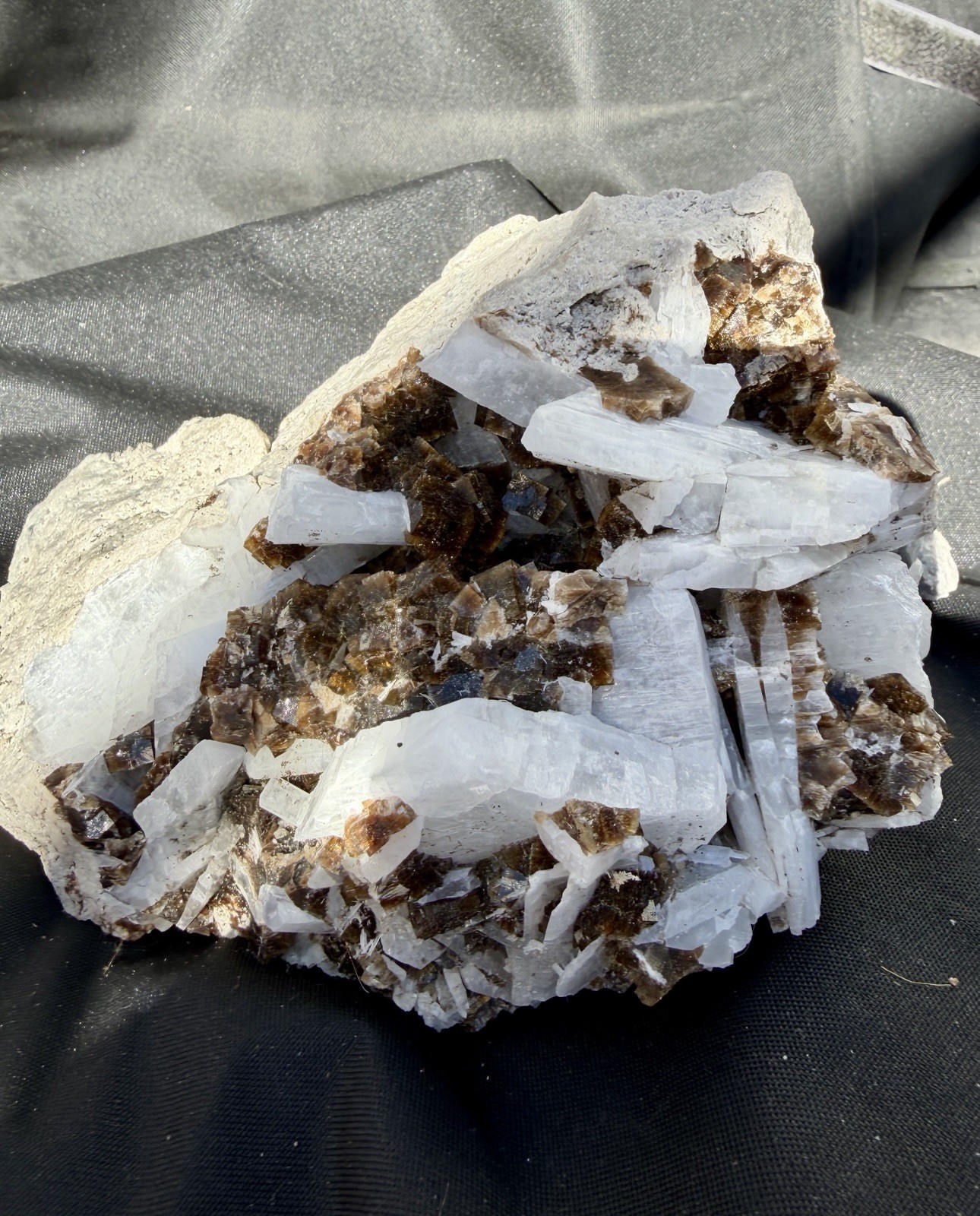 Mineral specimen containing brown fluorite and white celestite crystals.
