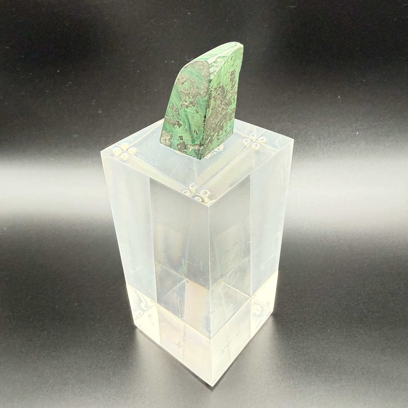 Dark green banded malachite on a lucite Base artist Unknown Signed – “?” Ax