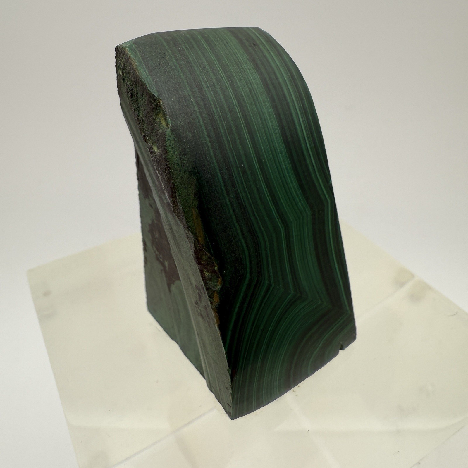 Dark green banded malachite on a lucite Base artist Unknown Signed – “?” Ax