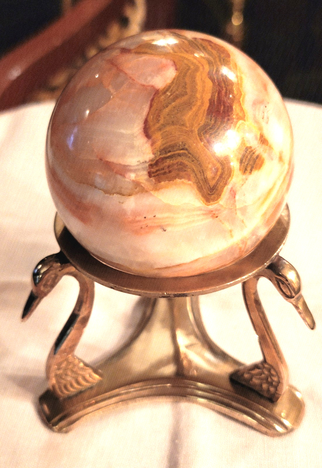 BEAUTIFUL RHODOCHROSITE SPHERE WITH POLISHED BRASS SWAN-HEADS STAND, 5’’