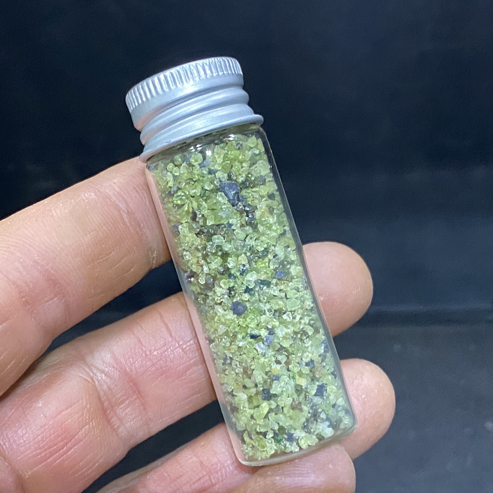Green Peridot Crystals in a Glass Bottle Jar
