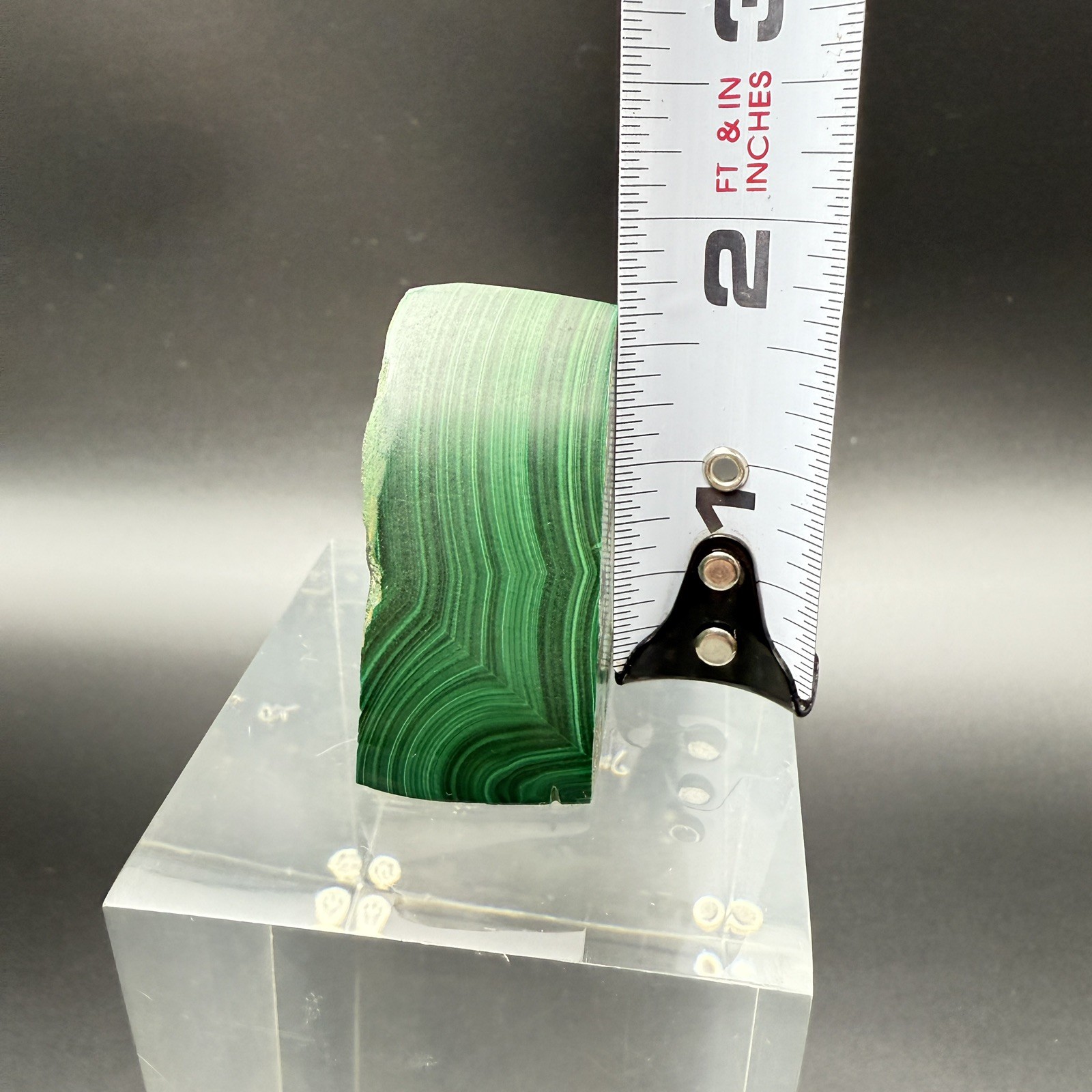 Dark green banded malachite on a lucite Base artist Unknown Signed – “?” Ax