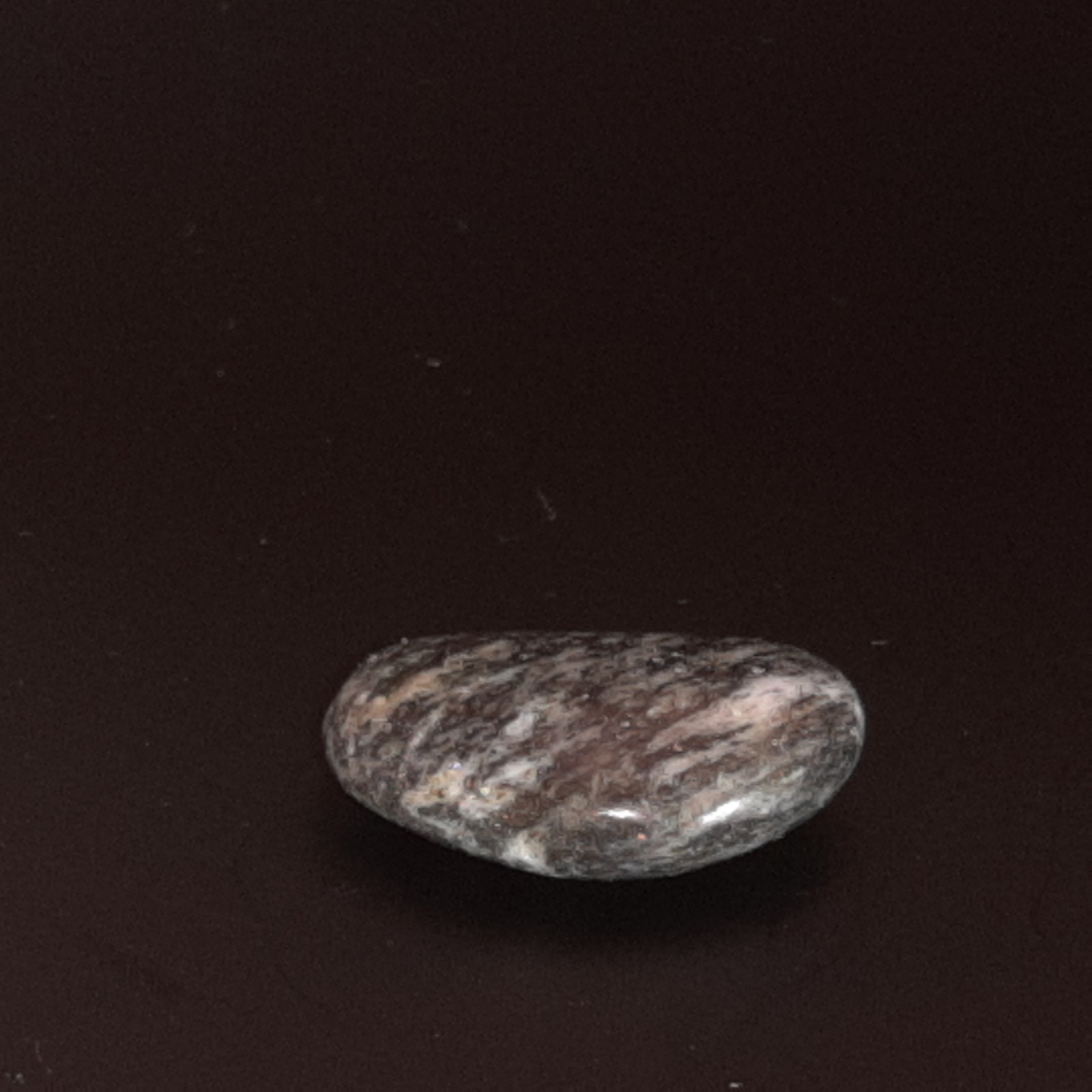 Polished Granite Black and White with some brown. Oval Shape Approx. 2 cm