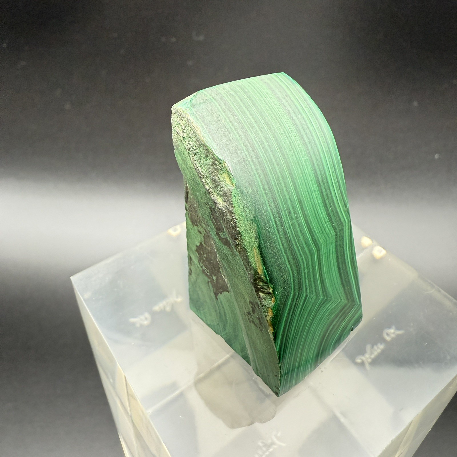 Dark green banded malachite on a lucite Base artist Unknown Signed – “?” Ax
