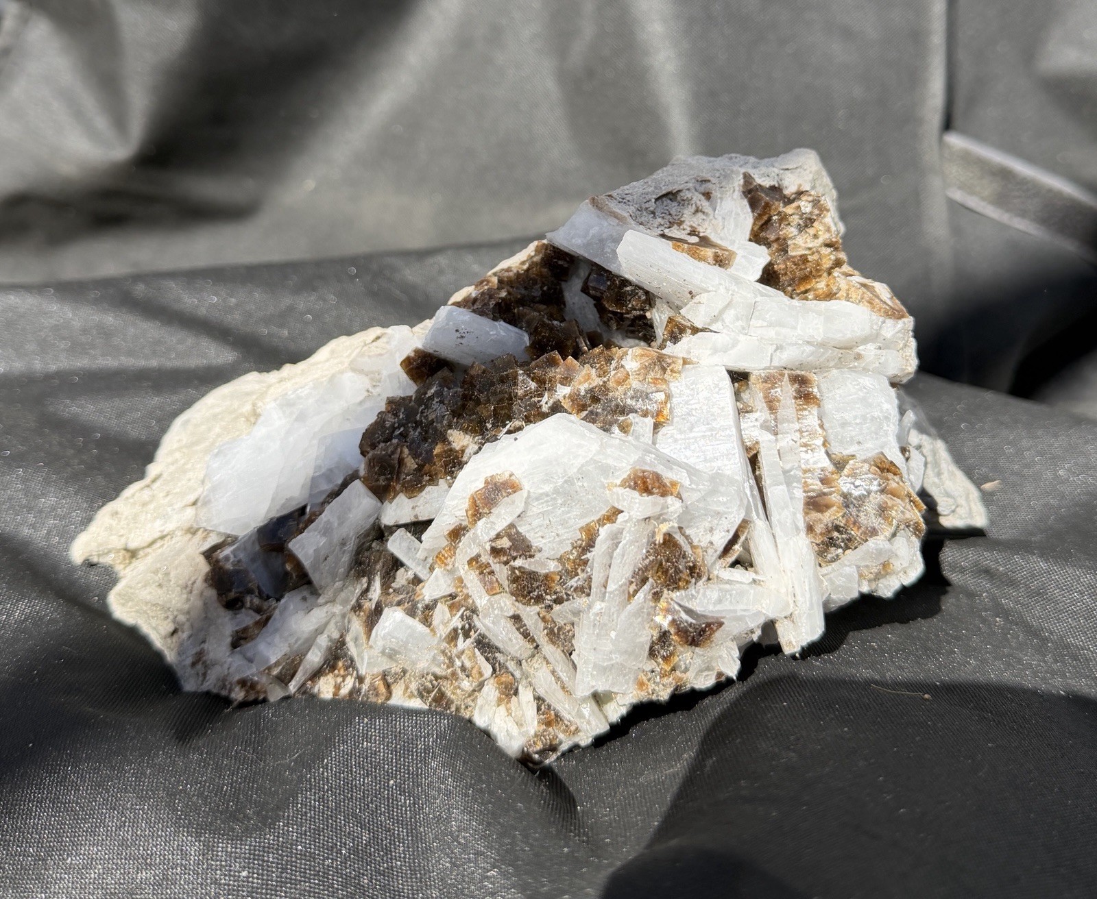 Mineral specimen containing brown fluorite and white celestite crystals.