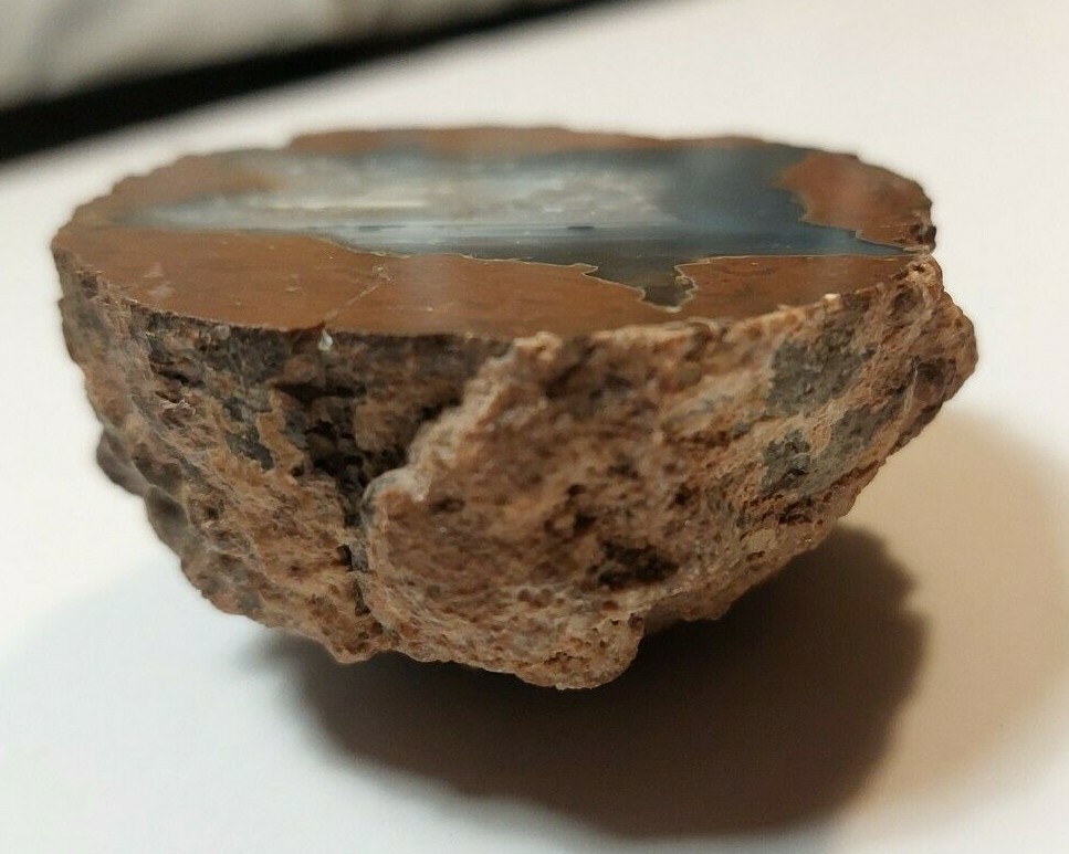 ENHYDRO AGATE GEODE. 3″ X 2 1/2″. LIGHT SHINES THRU LEAVES A YELLOWISH HUE