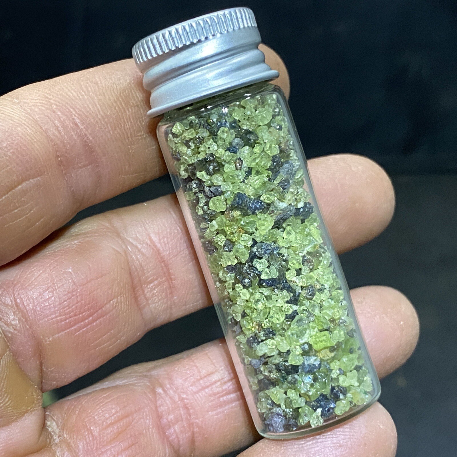 Green Peridot Crystals in a Glass Bottle Jar