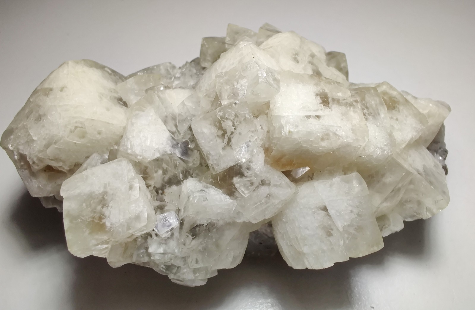 Calcite crystals on matrix, unique form, fluorescent white. 215 grams.