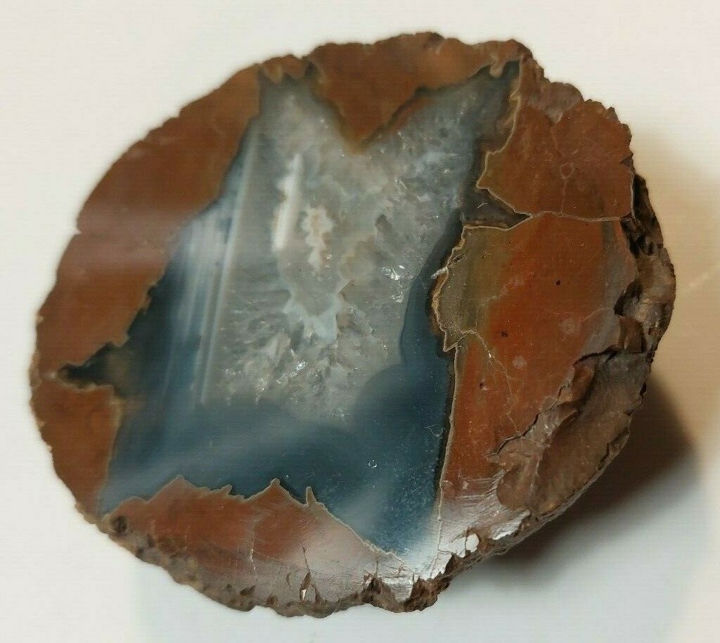 ENHYDRO AGATE GEODE. 3″ X 2 1/2″. LIGHT SHINES THRU LEAVES A YELLOWISH HUE