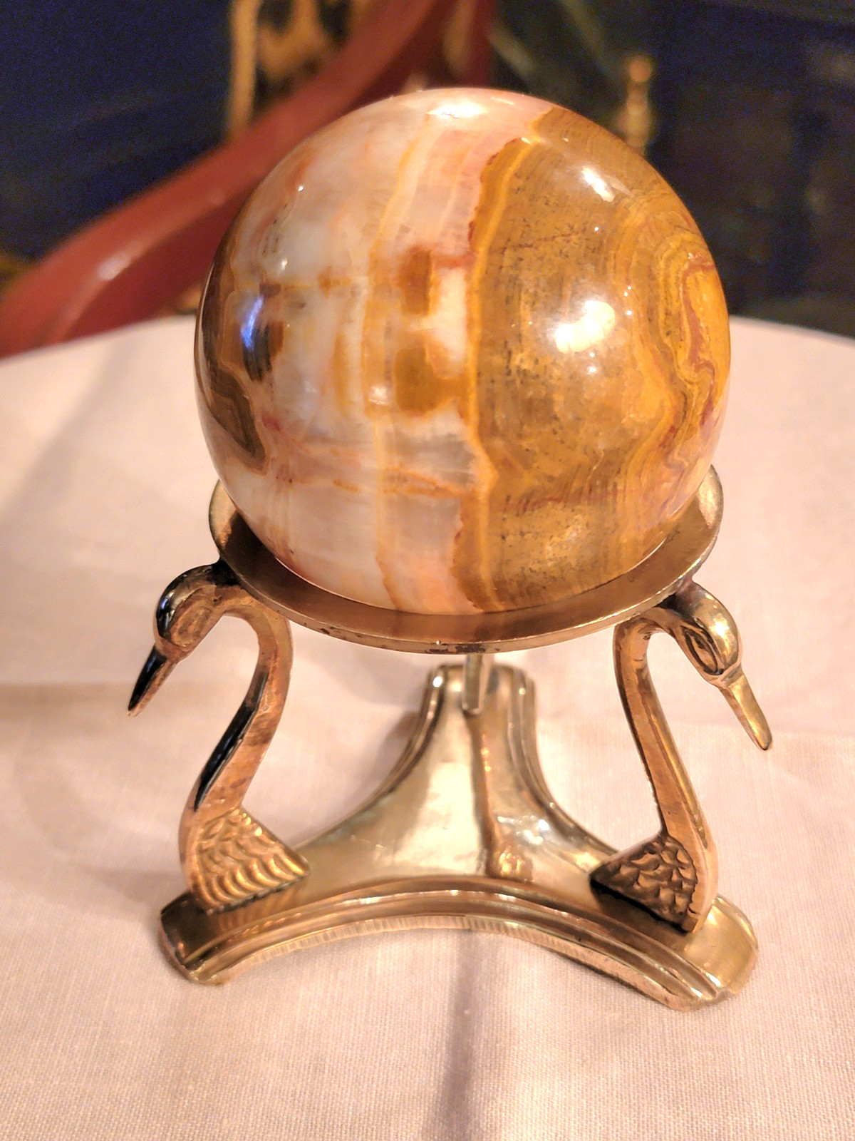 BEAUTIFUL RHODOCHROSITE SPHERE WITH POLISHED BRASS SWAN-HEADS STAND, 5’’