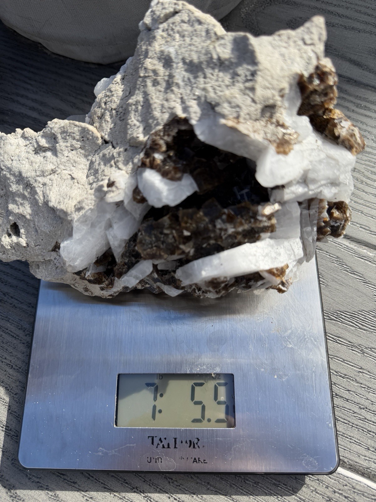 Mineral specimen containing brown fluorite and white celestite crystals.