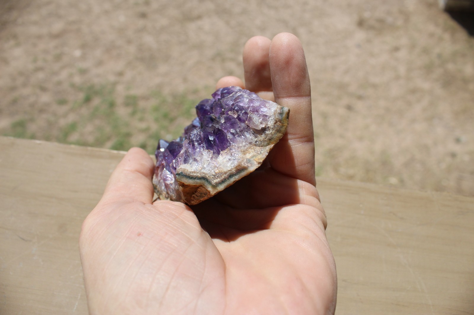 Amethyst geode specimen with brass holder