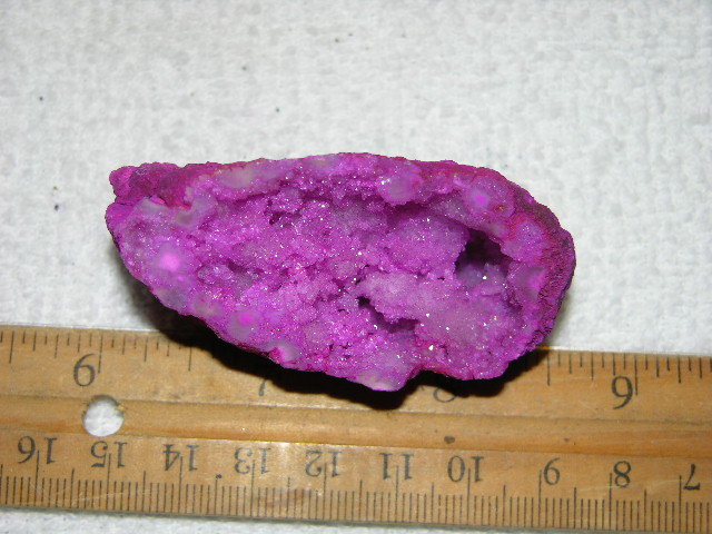 Geode cut & polished half with colored crystal center 2.5 inch E59